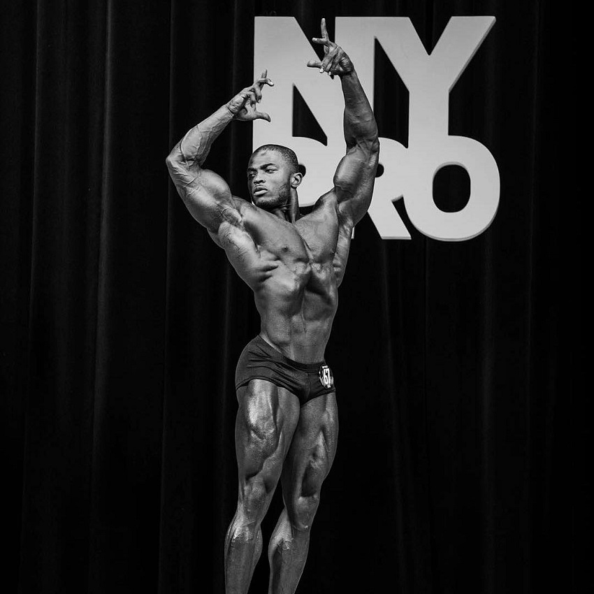 Kenneth Owens posing in a New York Pro IFBB Bodybuilding Show