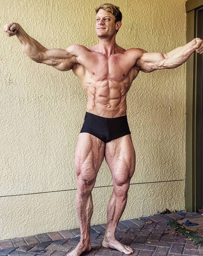 Tyler Garceau flexing his muscles for a photo