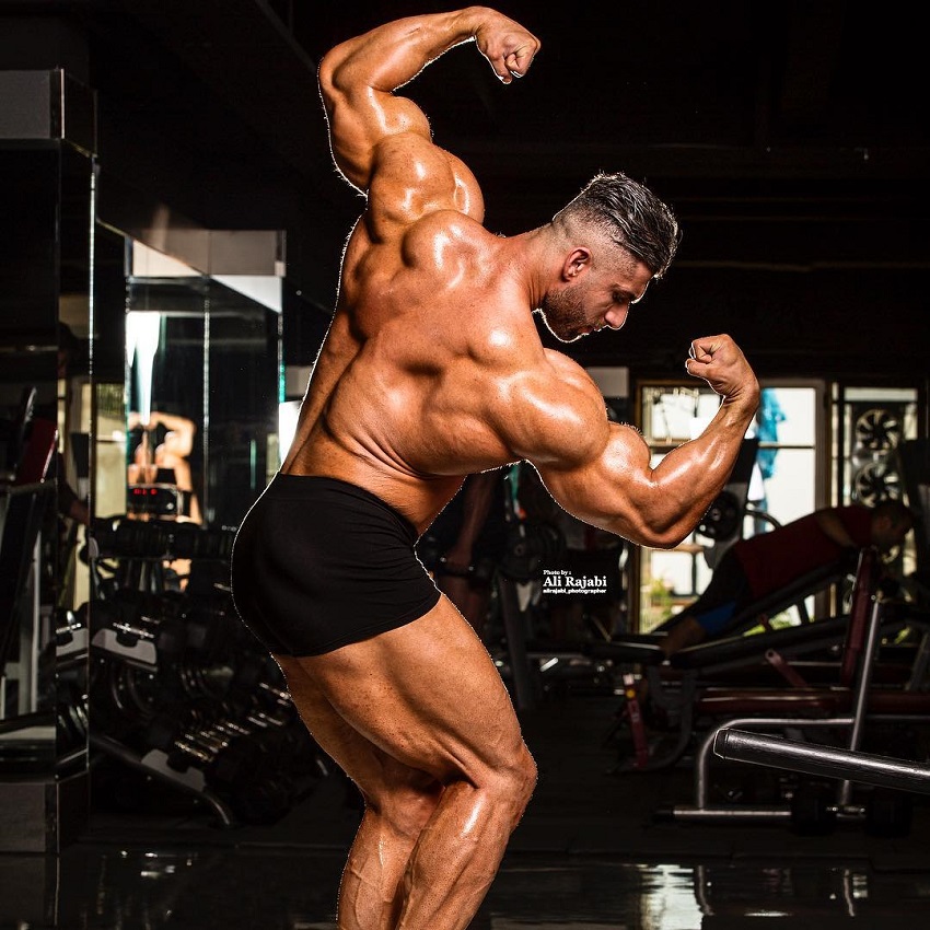 Ahmad Parvin performing a back double biceps looking riped