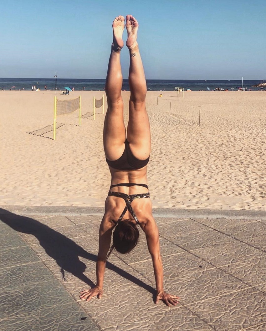 Beaa Allo doing a handstand on the beach