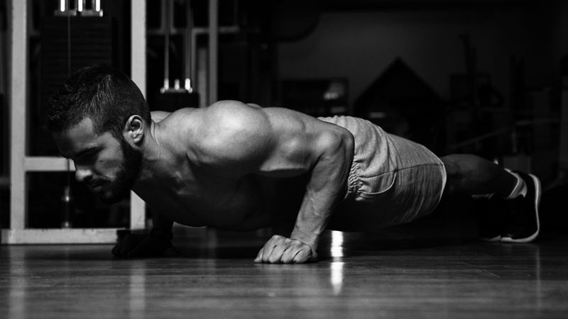 Bodybuilder performing press-ups