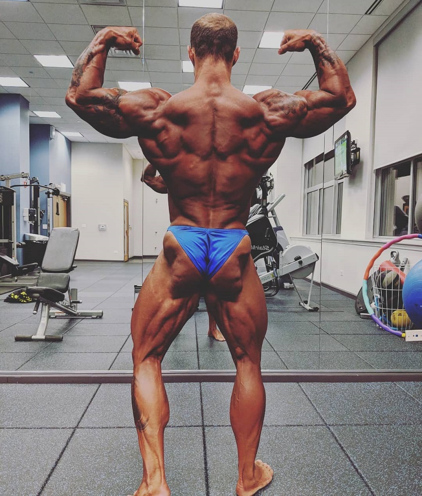 Caleb Blanchard doing a back double biceps flex looking ripped