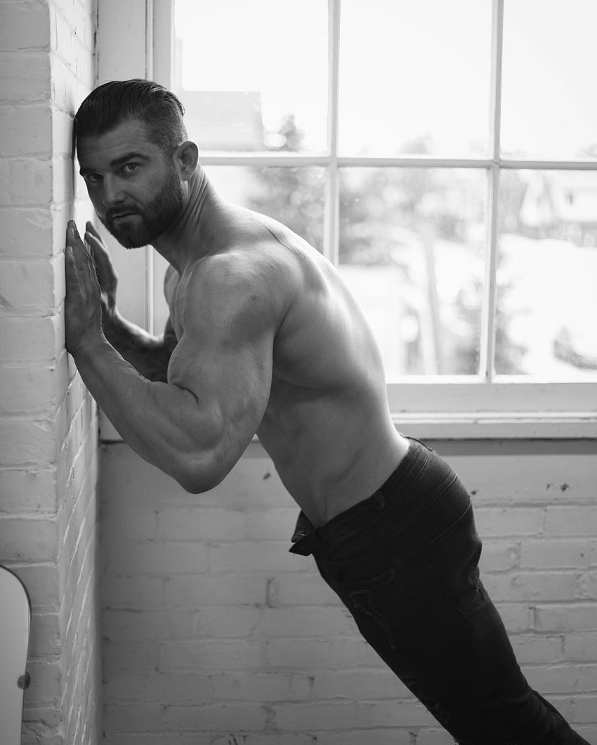 Jase Stevens leaning against a wall during a photo shoot