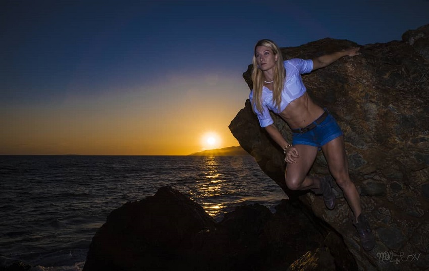 Jessie Graff posing by the rock during a sunset