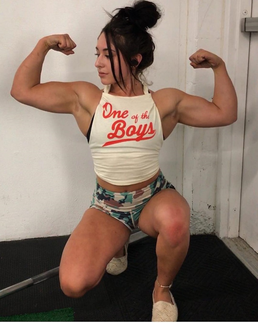 Samyra Zane Abweh doing a front double biceps flex for the camera