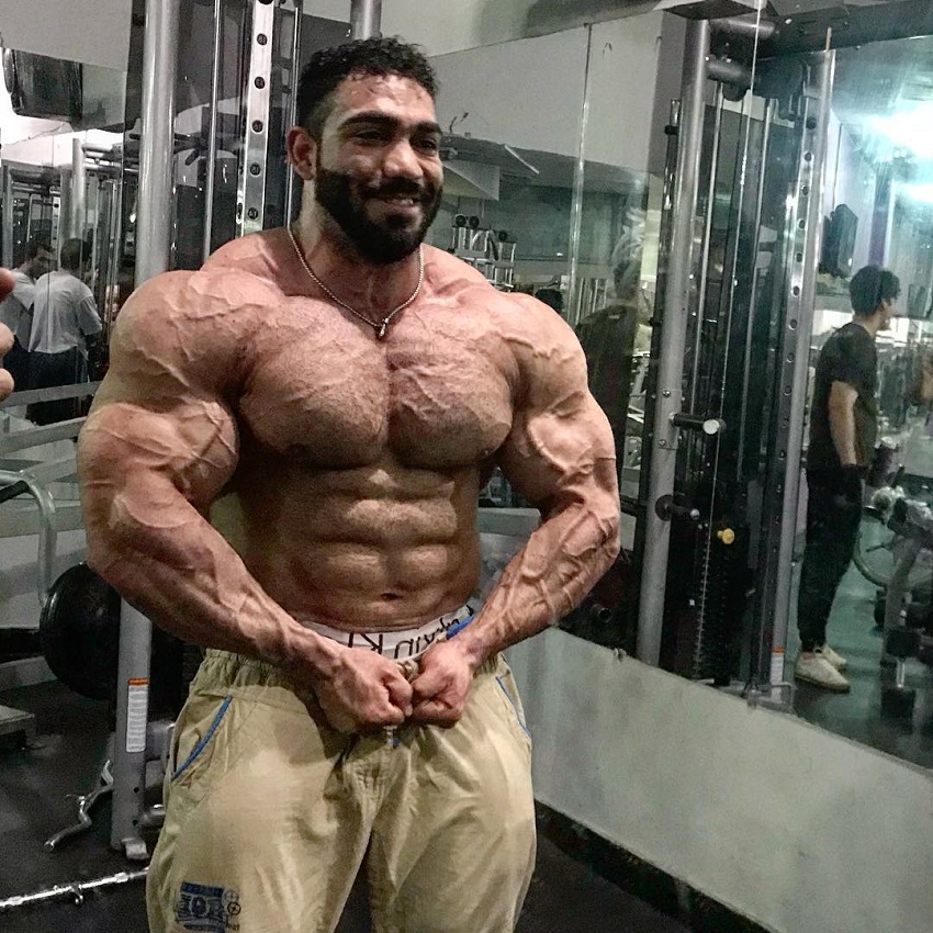 Yasin Qaderi performing a most muscular pose looking strong and ripped