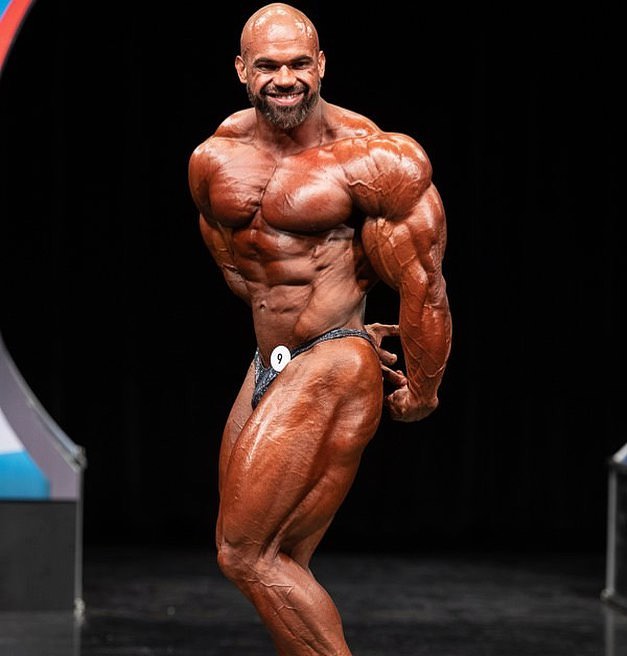 Alexis Rivera Rolon doing a side triceps pose on a bodybuilding stage, looking confident and impressive