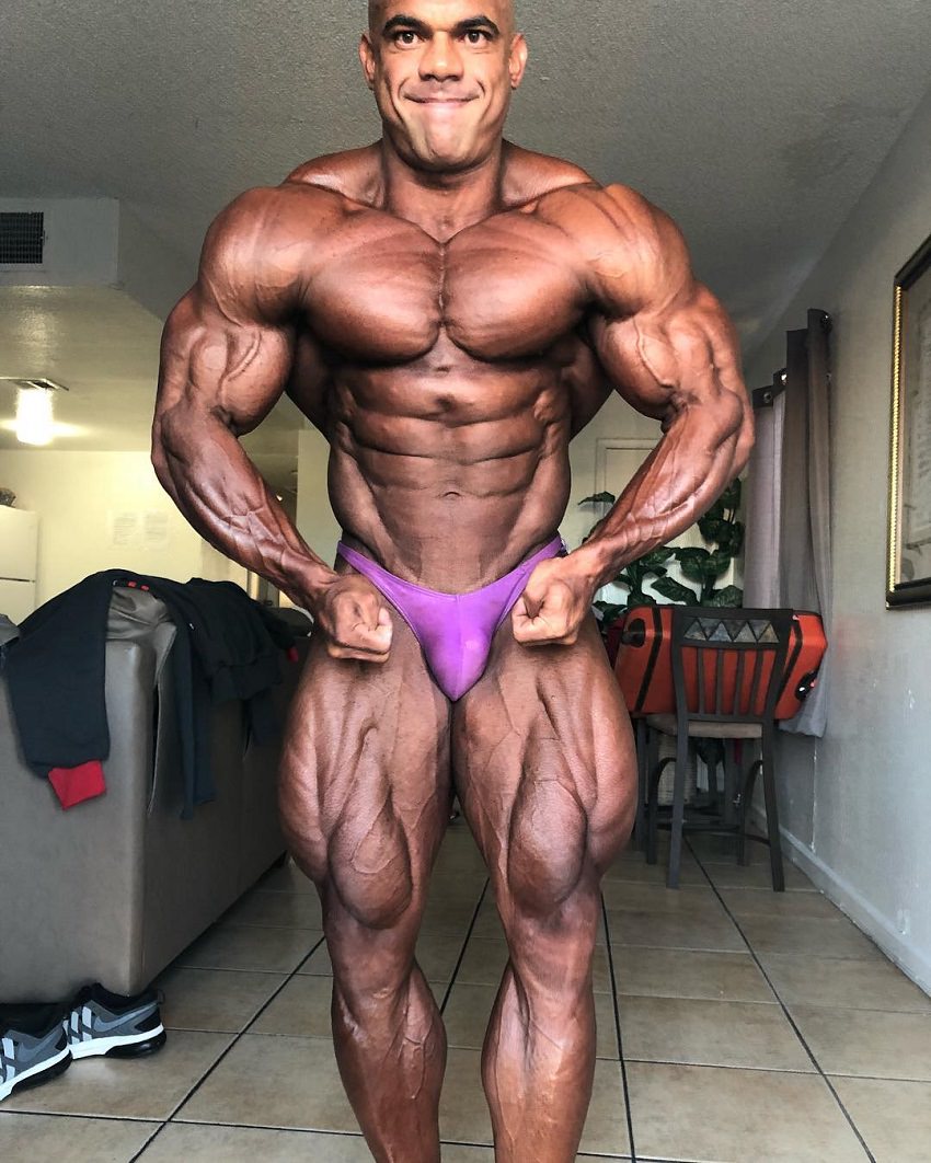 Alexis Rivera Rolon posing shirtless, tanned up, looking huge and ripped, ready for a show