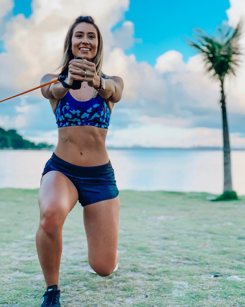 Aline Mareto training with resistance bands on a beach