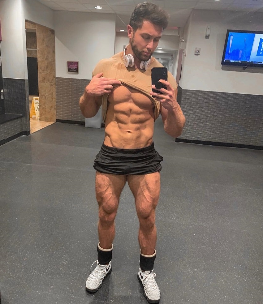 Daniel Zukich taking a selfie of his ripped abs and vascular legs