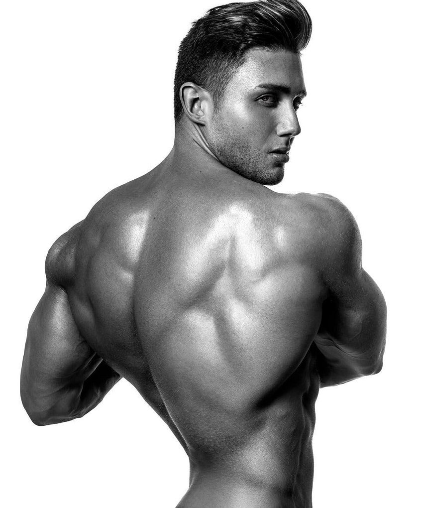 Daniel Zukich posing shirtless in a professional modeling photo shoot, showing off his wide and aesthetic back muscles