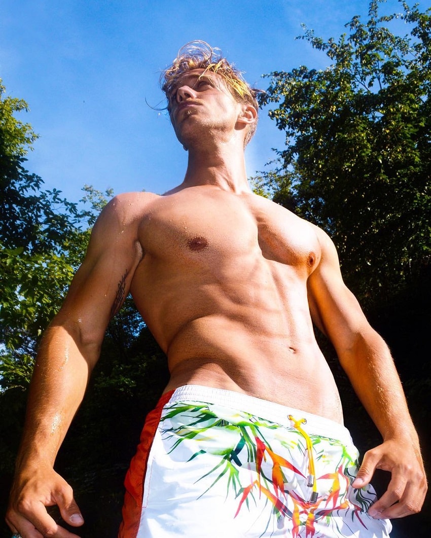 Edoardo Santonocito standing shirtless outdoors looking fit and lean