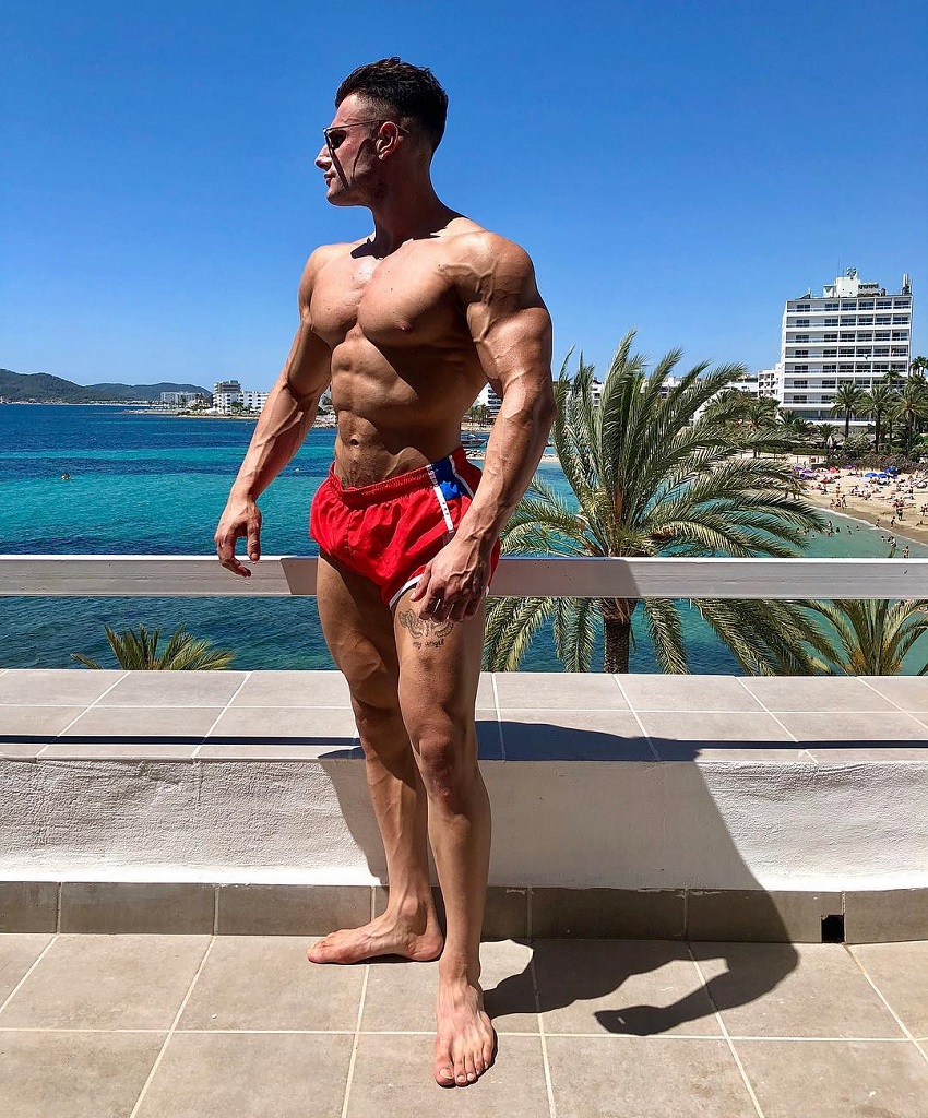 Francesco Della Vedova posing shirtless outdoors looking ripped and swole