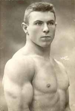 George Hackenschmidt in his youth, standing shirtless showcasing his strong and ripped muscles