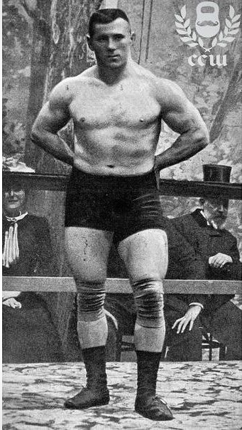 George Hackenschmidt posing shirtless in front of a crowd