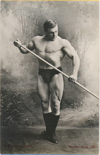 George Hackenschmidt standing shirtless and posing for a picture, looking muscular