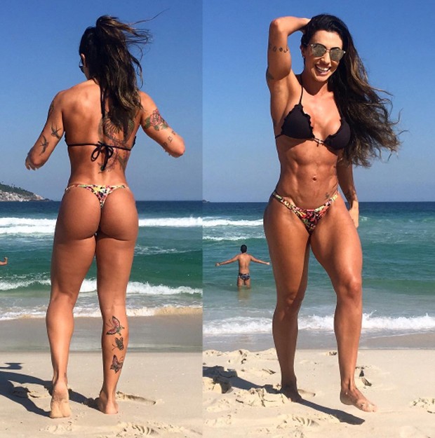 Jaque Khury posing on the beach, her abs and glutes looking amazingly curvy and fit