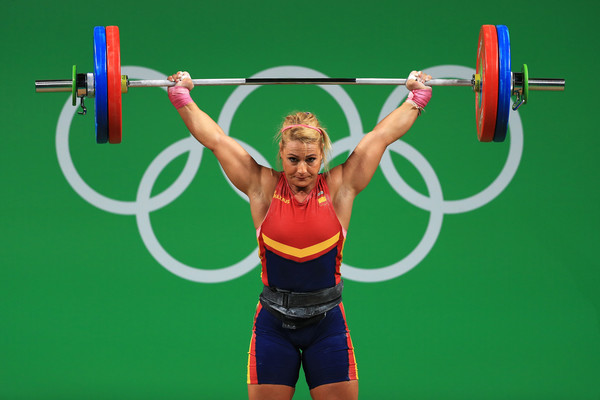 Lidia Valentin Perez doing an overhead barbell press at the Olympics