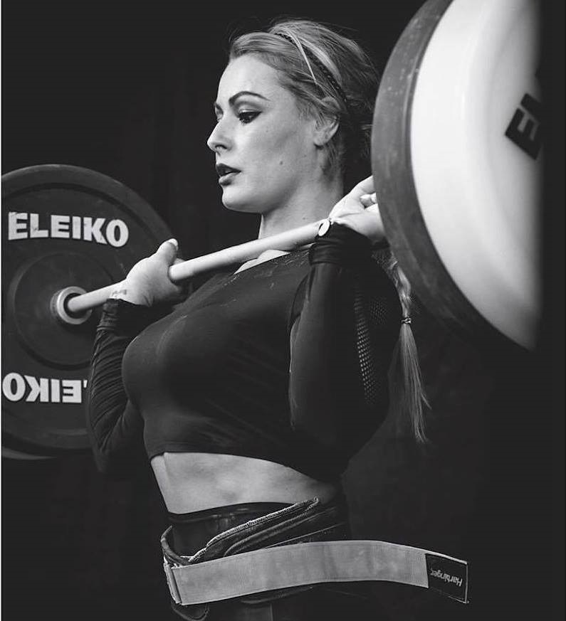 Lidia Valentin Perez lifting a heavy barbell during a weightlifting contest