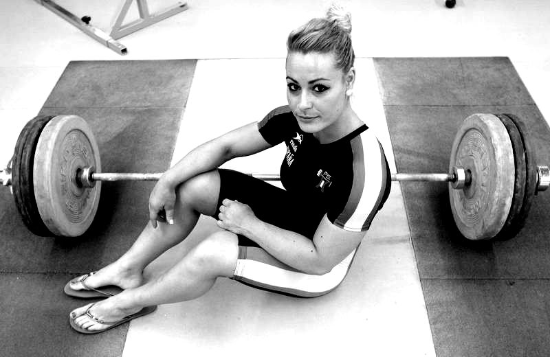 Lidia Valentin Perez posing seated down on the floor looking fit and lean