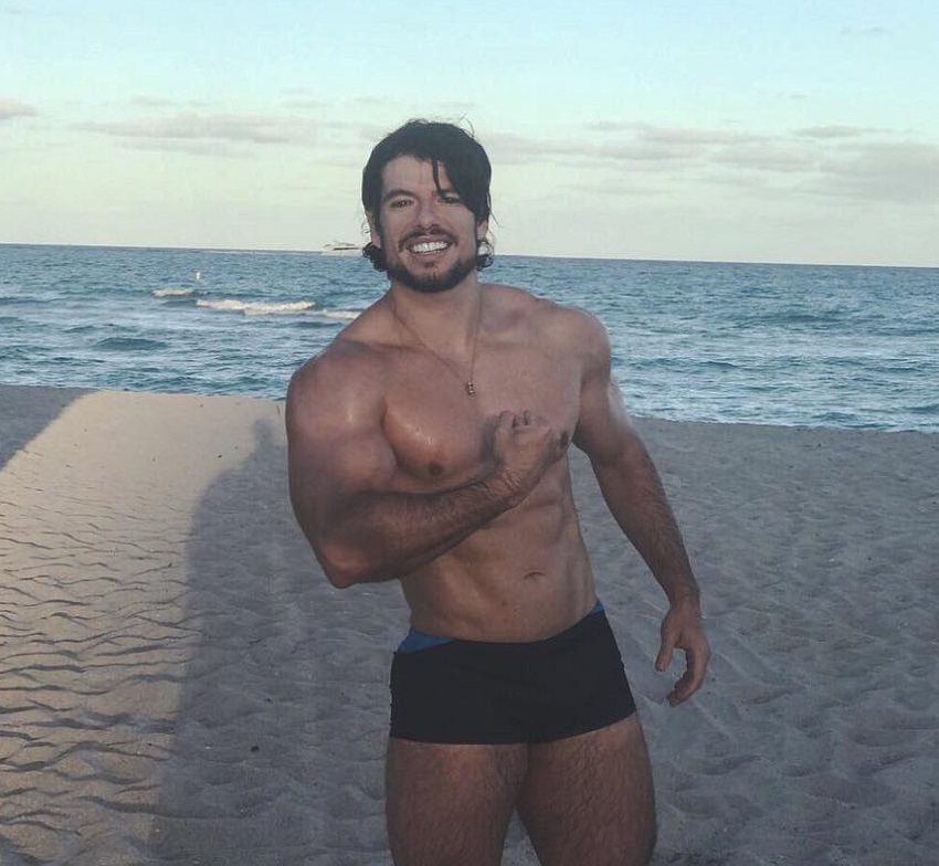 Lucas Giovani flexing on the beach looking fit and lean