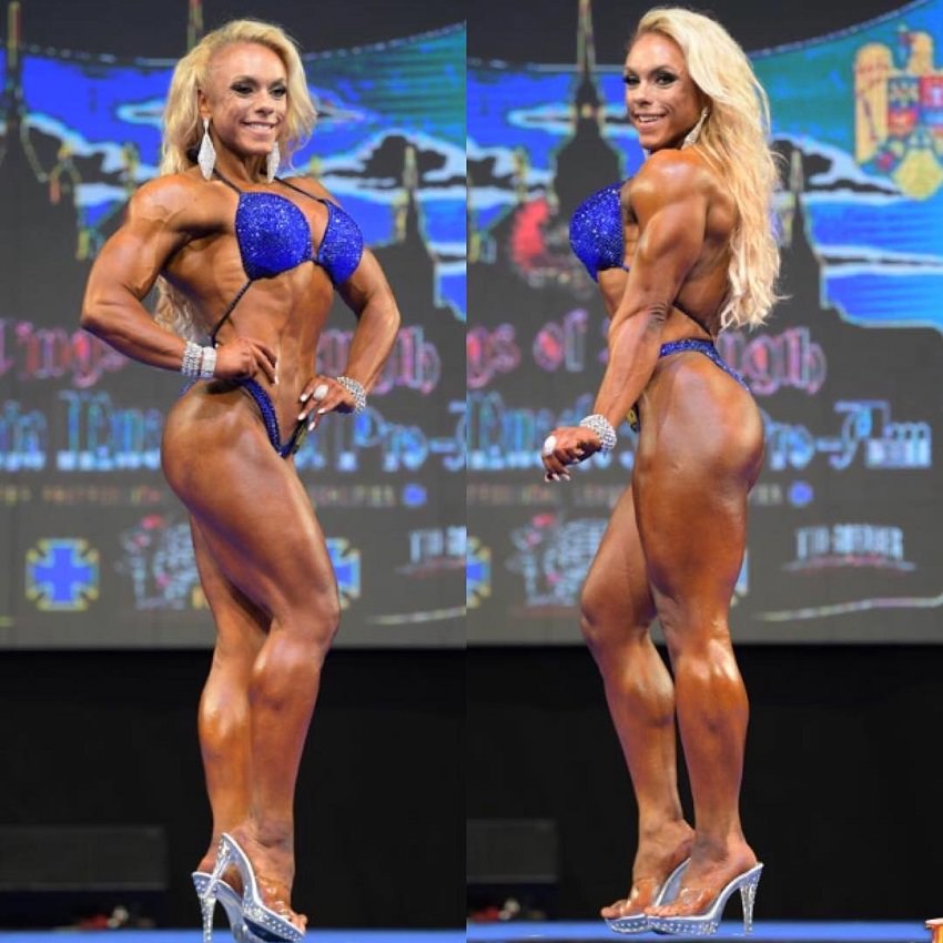 Minna Pajulahti posing on the bodybuilding stage looking toned and aesthetic