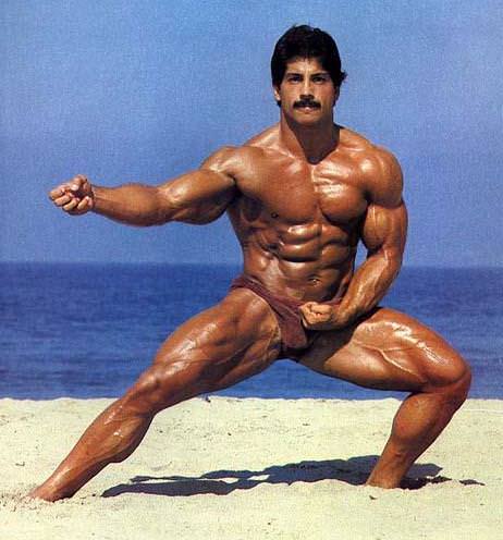 Ray Mentzer standing shirtless in a Martial arts pose on a beach