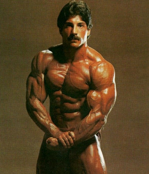 Ray Mentzer flexing his shirtless and ripped body for the photo shoot