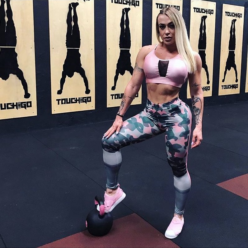 Rochelle Michielin posing with her leg on top of a kettlebell, looking fit and lean