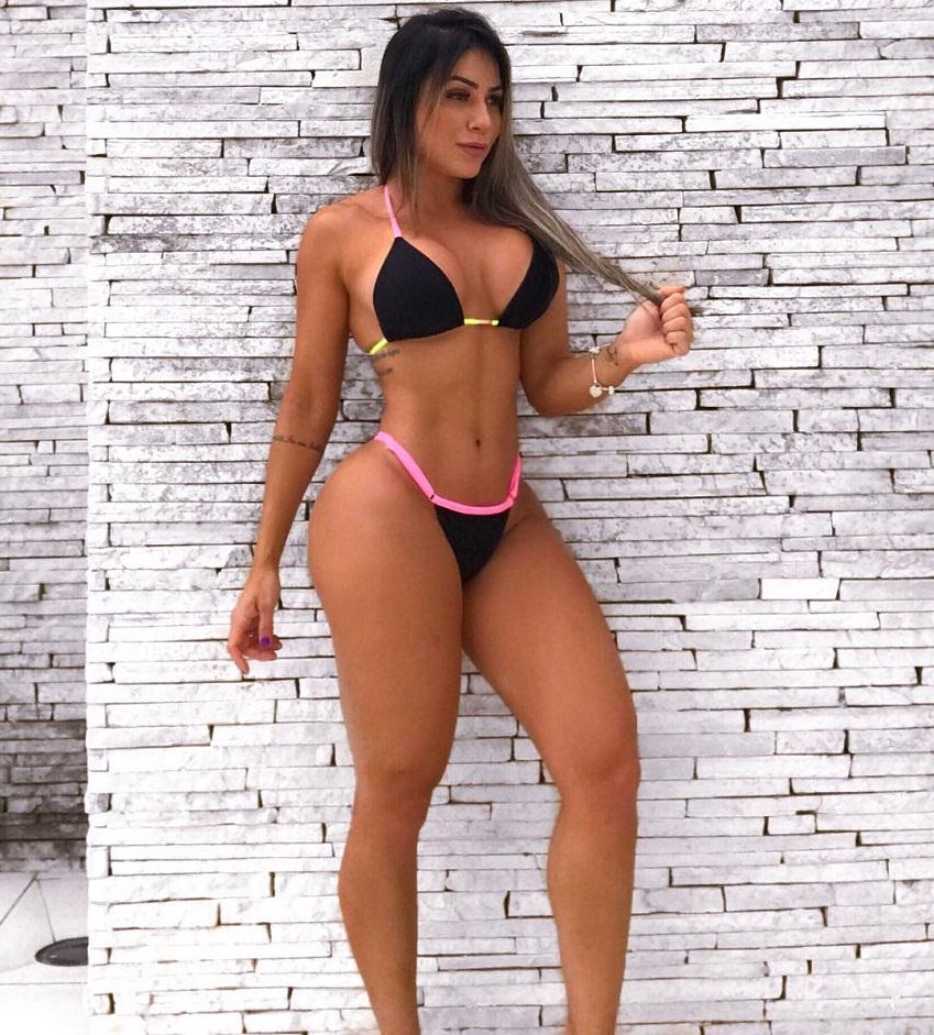 Tatiane Almeida posing in a bikini looking toned and fit