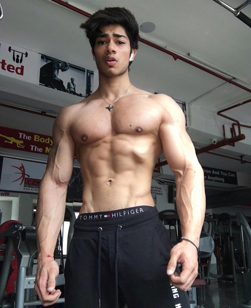 Vasu Mittal posing in the gym looking strong and ripped