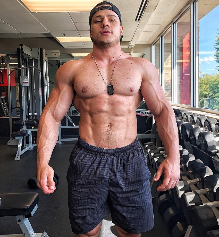 Caio Bottura posing shirtless in the gym