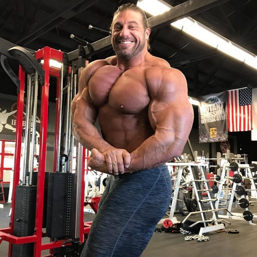 Gabe Moen hitting a shirtless side chest pose in the gym