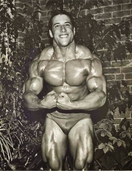 Mike Quinn doing a most muscular pose looking ripped and swole