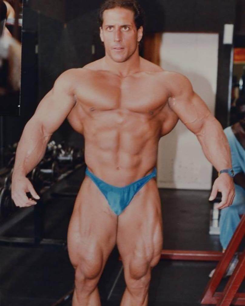 Mike Quinn posing shirtless looking huge and ripped