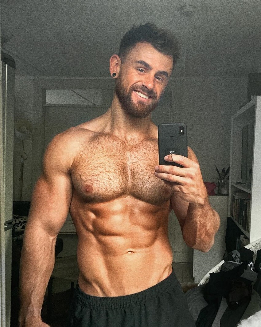 Nathan McCallum taking a selfie of his shirtless ripped body
