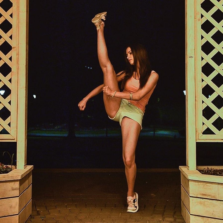 Sara Damnjanovic raising her leg up high practicing taekwondo