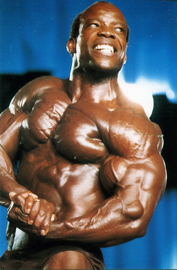 Albert Beckles flexing side chest looking ripped