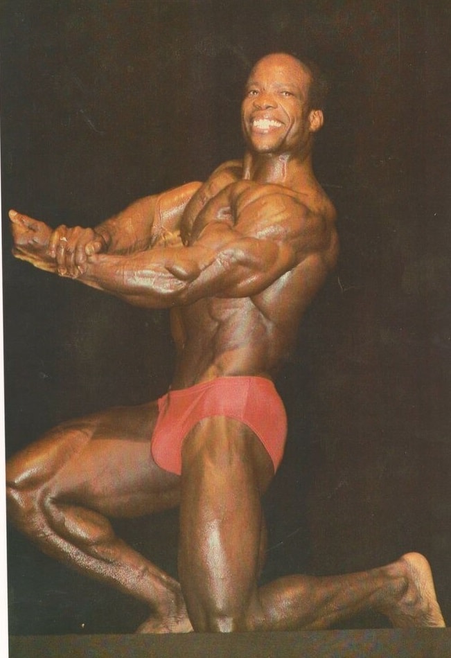 Albert Beckles posing on the bodybuilding stage