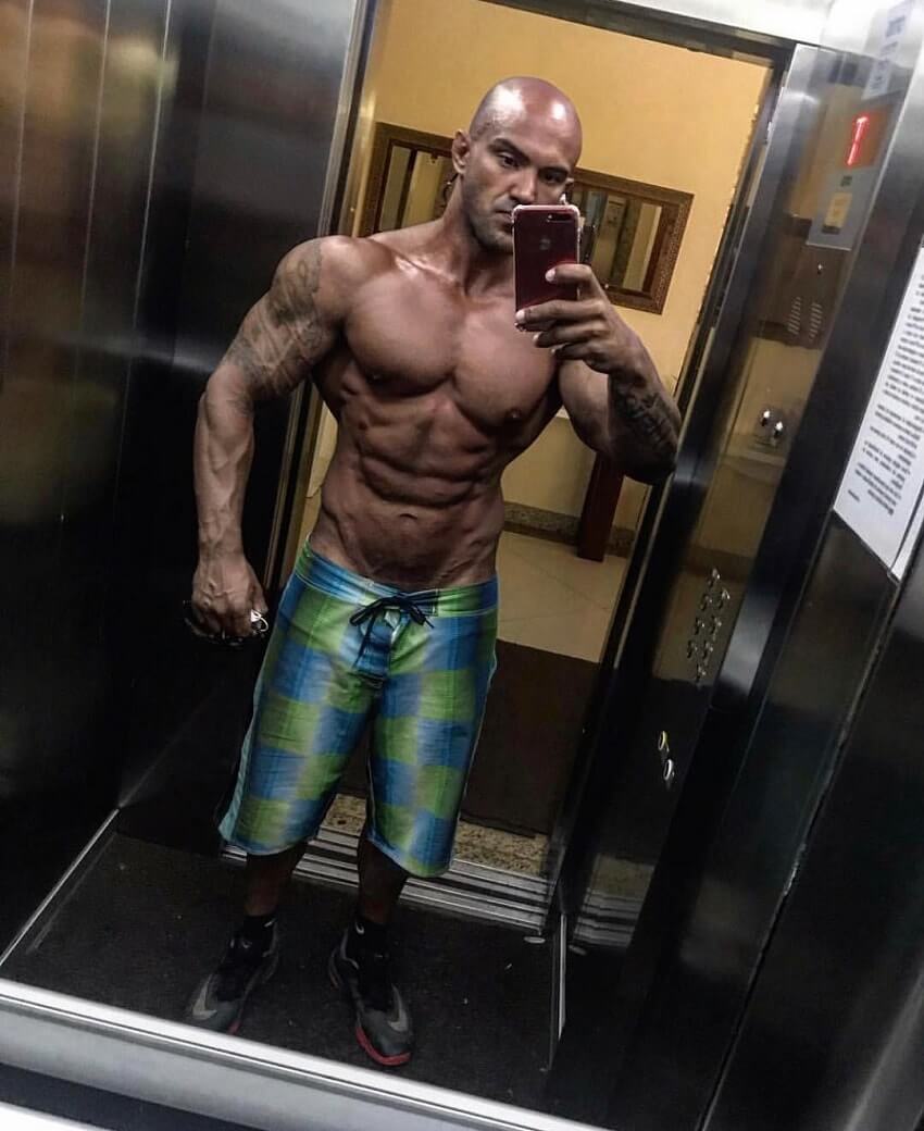 Danilo Franca taking a shirtless elevator selfie, looking muscular and ripped