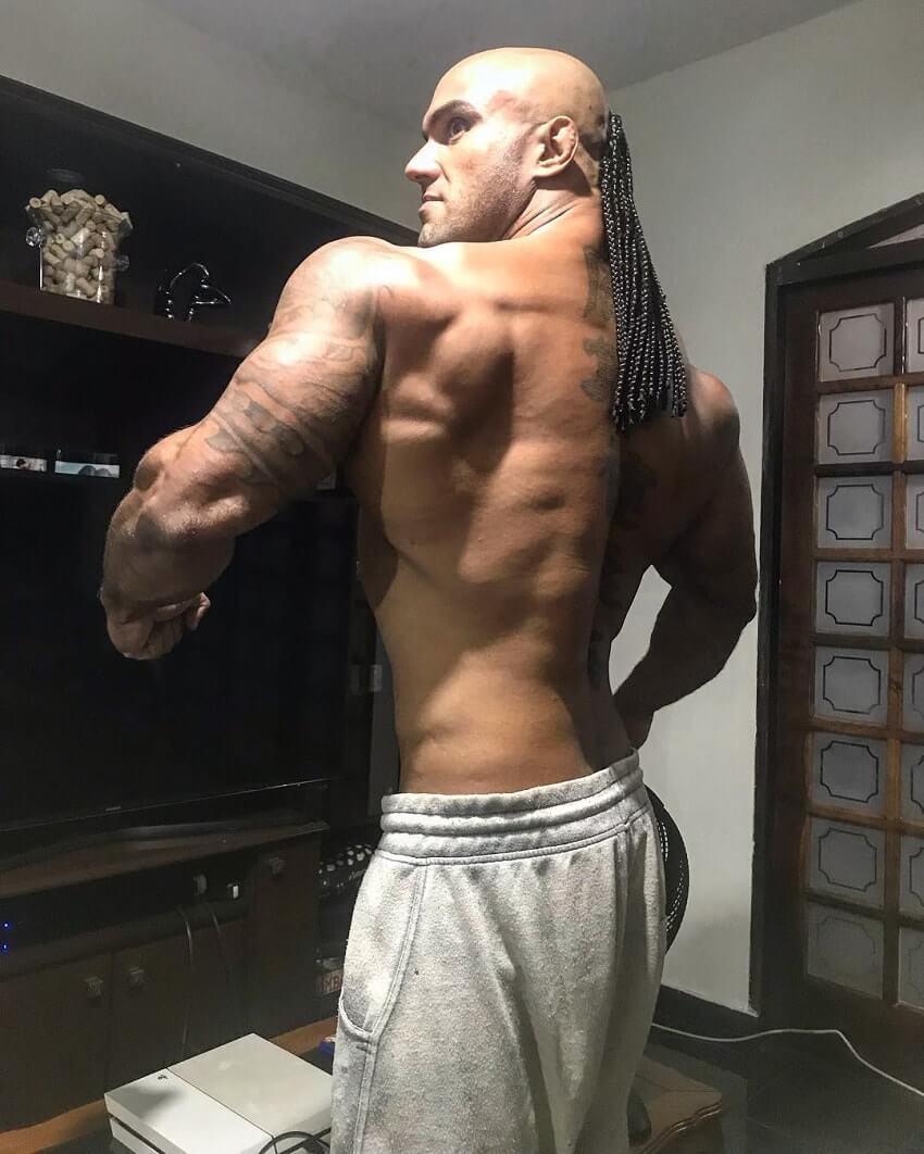 Danilo Franca spreading his lats wide in a room