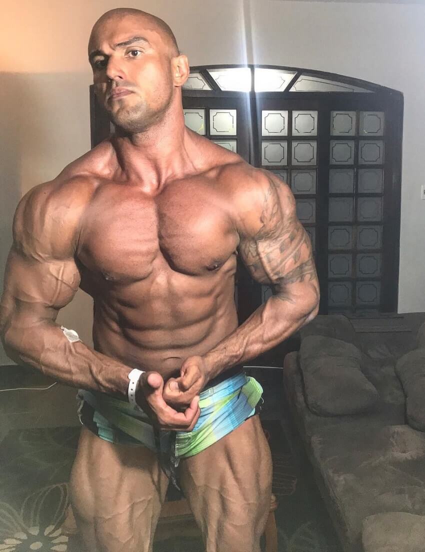 Danilo Franca flexing shirtless looking ripped and swole