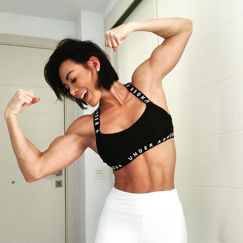 Danni Levy flexing her biceps for the camera