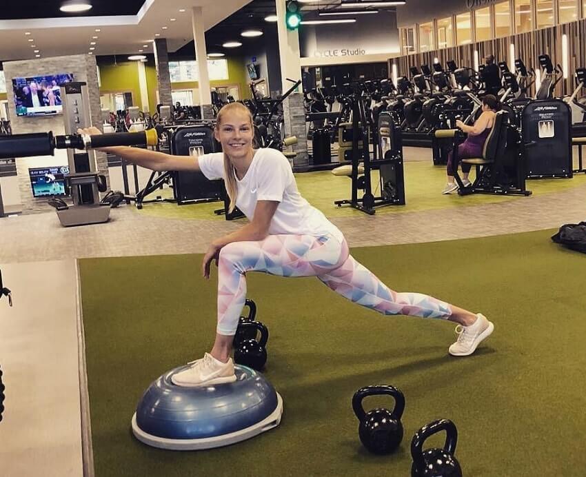 Darya Klishina doing Pilates exercises in the gym