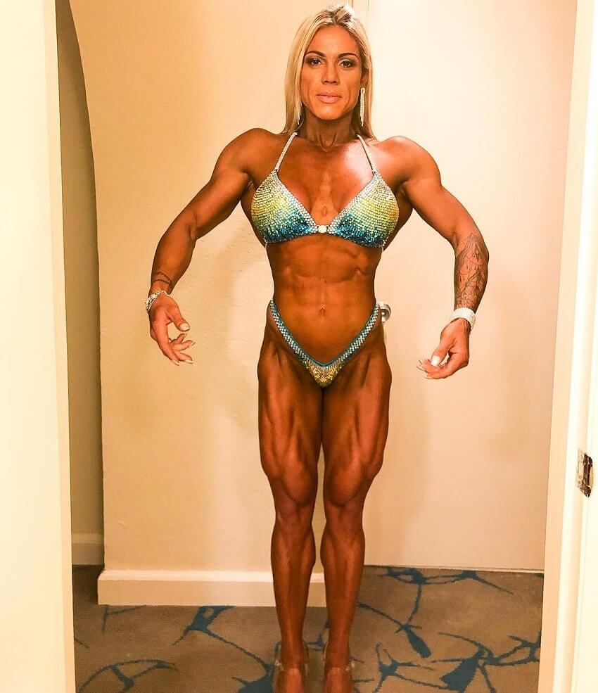 Dora Rodrigues practicing posing for a contest, wearing a bikini, looking fit and strong