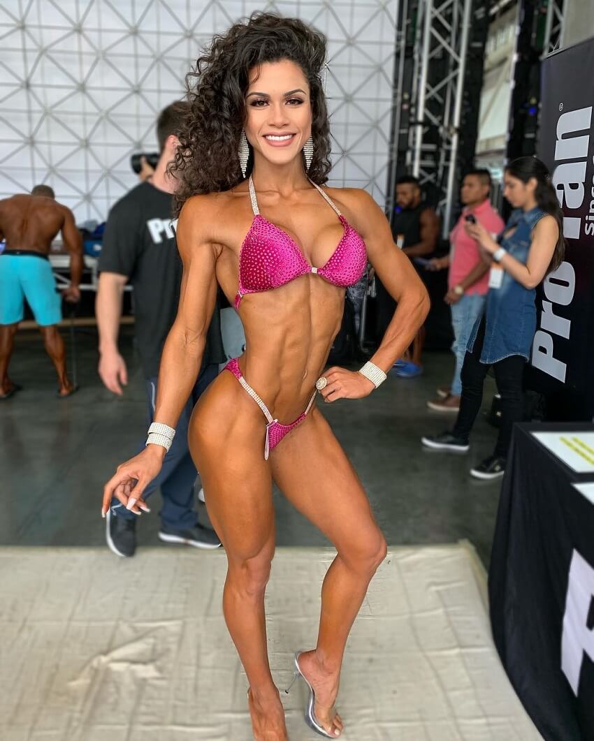 Etila Santiago posing backstage during a bikini contest