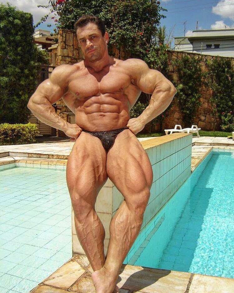 Fernando Sardinha when he was younger, posing shirtless by the pool, looking huge and ripped