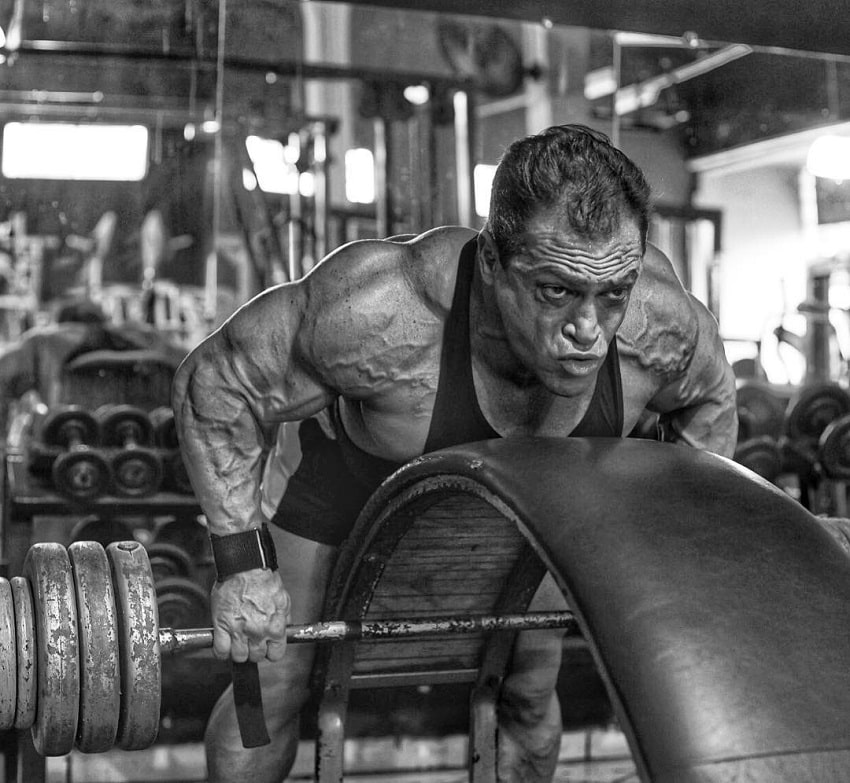 Fernando Sardinha doing heavy barbell rows in the gym