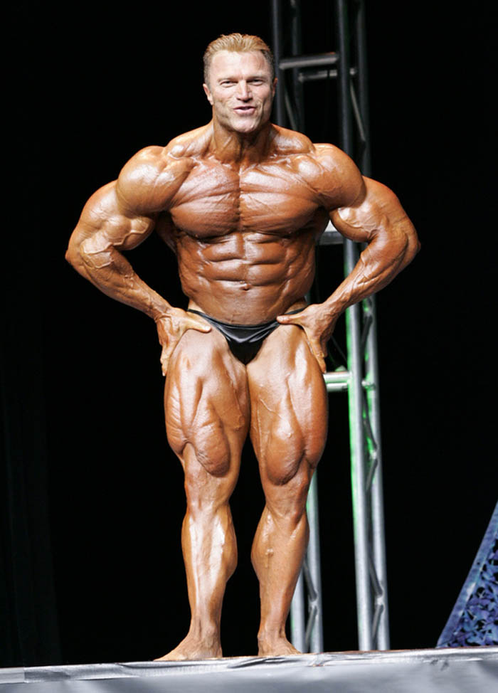 Gary Strydom flexing in a bodybuilding contest looking ripped