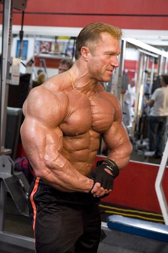 Gary Strydom posing shirtless in the gym, looking huge and ripped